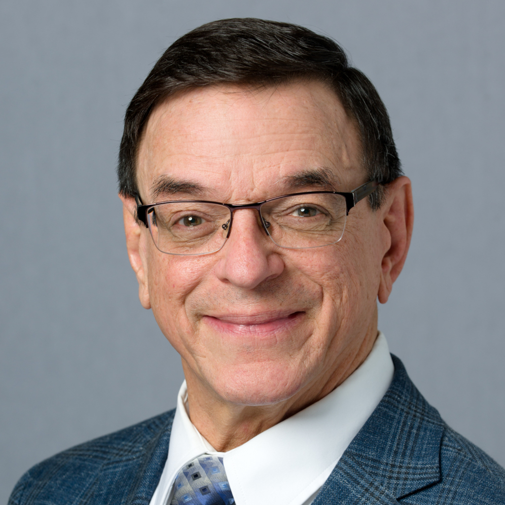 Greg Adair, founder of Affordable Home Care, in a blue plaid blazer and patterned tie.