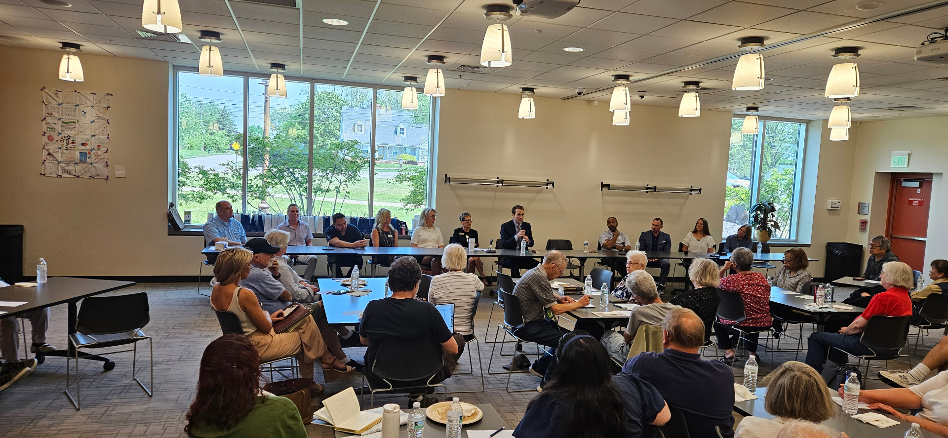 Senior Compass Group 'Ask the Advisor' panel at the Novi Public Library — Austin Adair, second from left in a purple shirt, seated with fellow Southeast Michigan senior-services advisors fielding audience questions from local families.
